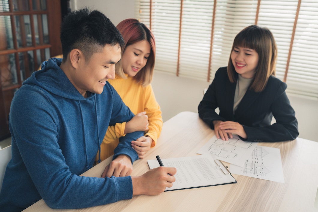 happy-young-asian-couple-realtor-agent_7861-1036